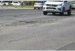 Bakkie nears a big pothole in the road