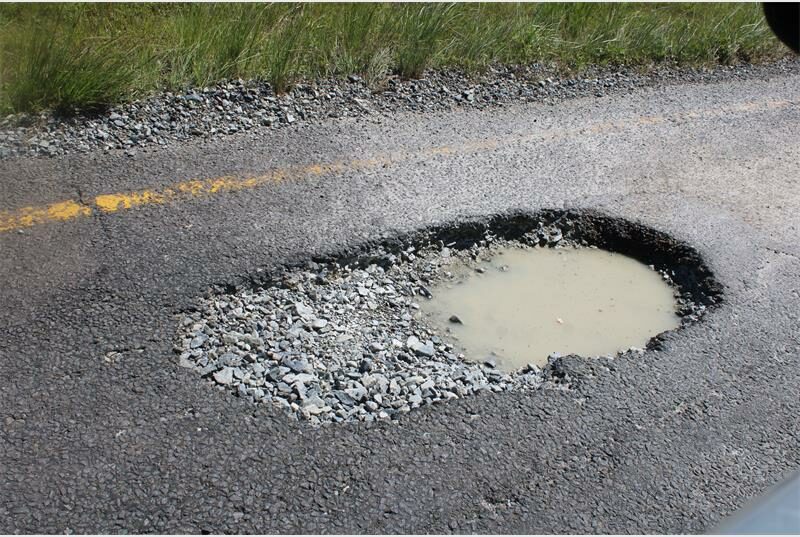 a huge and deep pothole