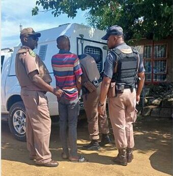 law enforcers load parolees into a van