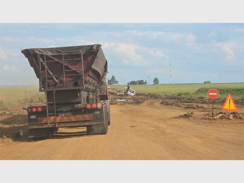truck tuck in the mud on a dirt road