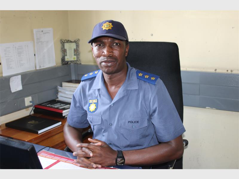 police officer sitting a a desk