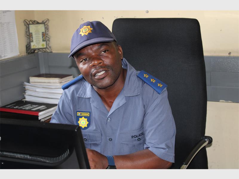 police officer sitting at a desk