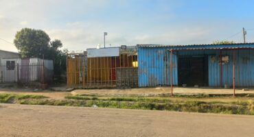 a blue tin shack structure