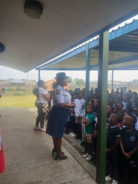 a policewoman speaks to children at a school