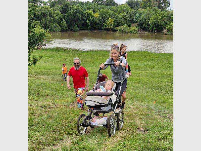 mother pushes a baby in a pram