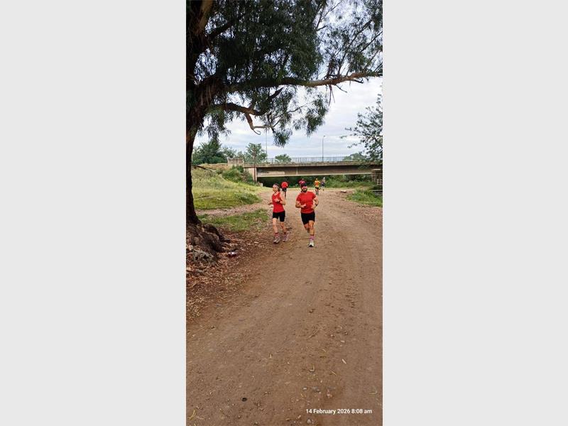 two people run a dirt road