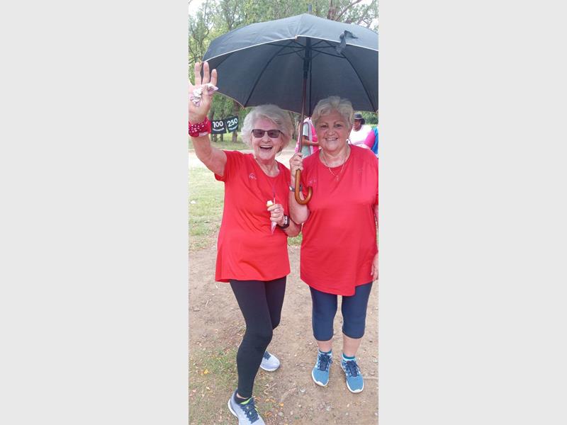 two elderly women wearing red shirts