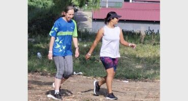 two people walk in the park