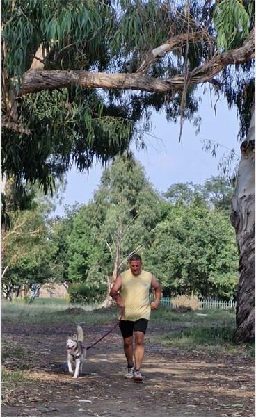 man running with a dog