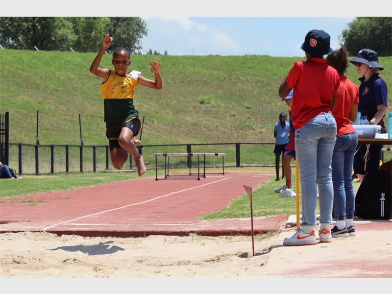 A child in the long jump pit