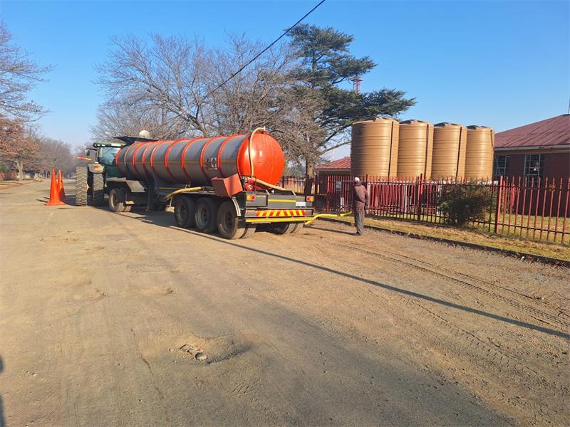 a water tanker on a dirt road