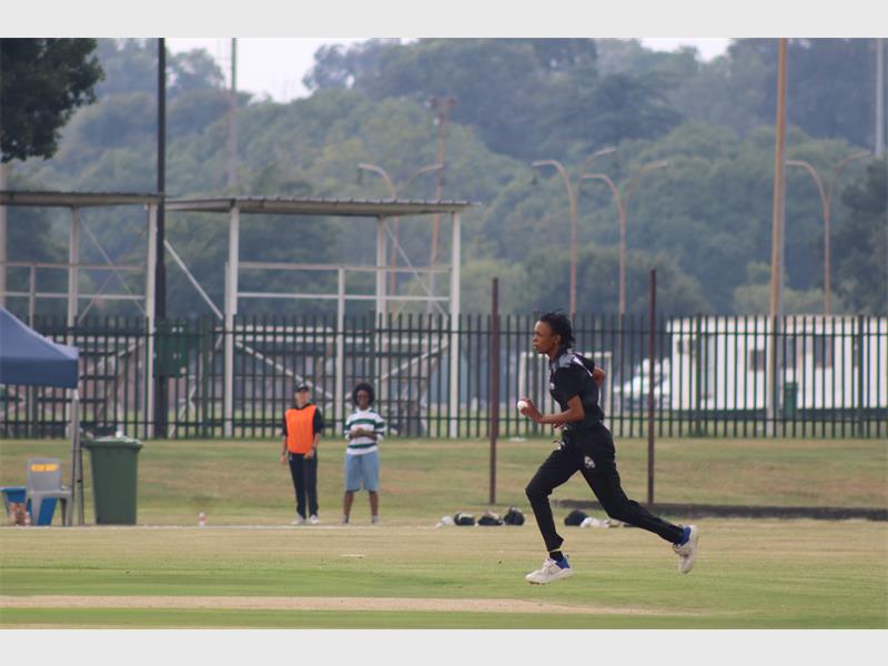 a bowler in black outfit