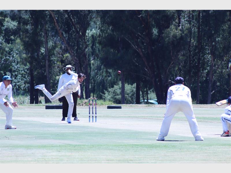 A cricket player bowls