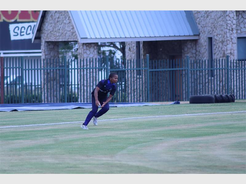 fielder wearing black outfit catches the ball