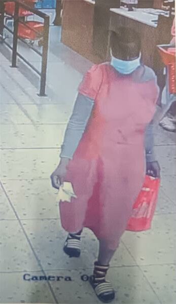 a woman in a pink dress in a shop