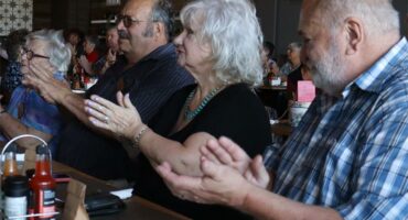 a row of people clap hands