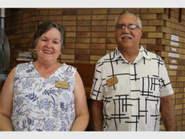 a woman and a man wearing badges