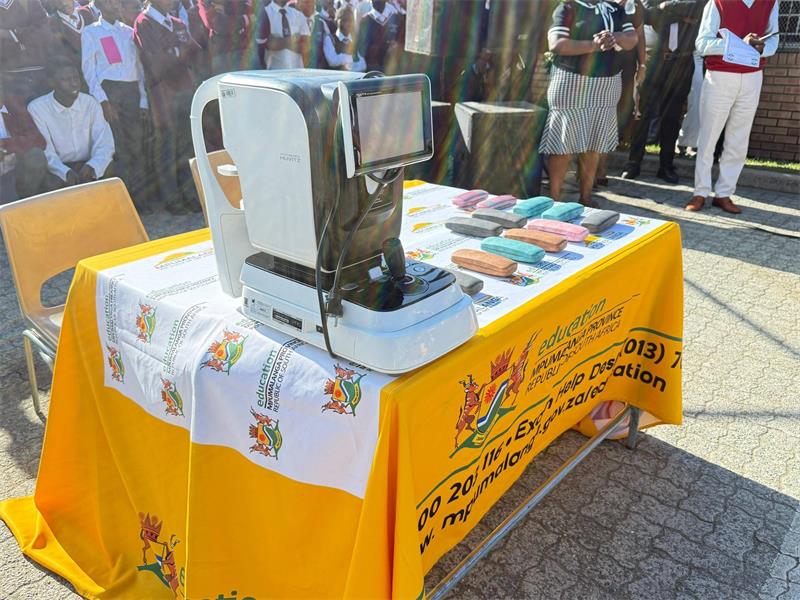 a table with an eye testing machine and spectacles