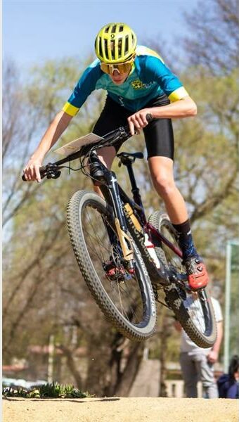 action photo of a boy on a mountain bike