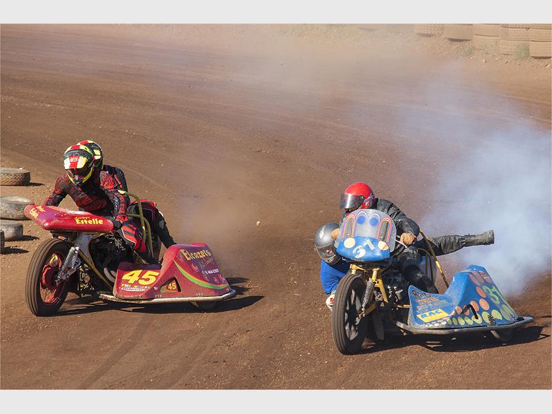 photo of two people racing on motorcycles with side cars