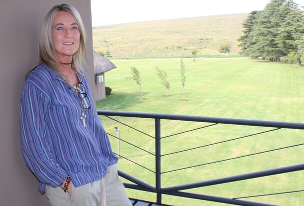 woman on a balcony overlooking a farm