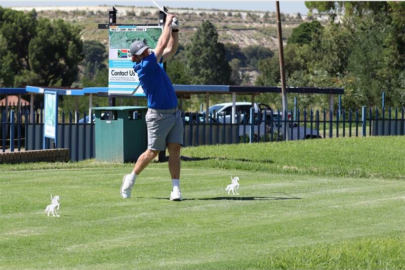 a golfer hits off
