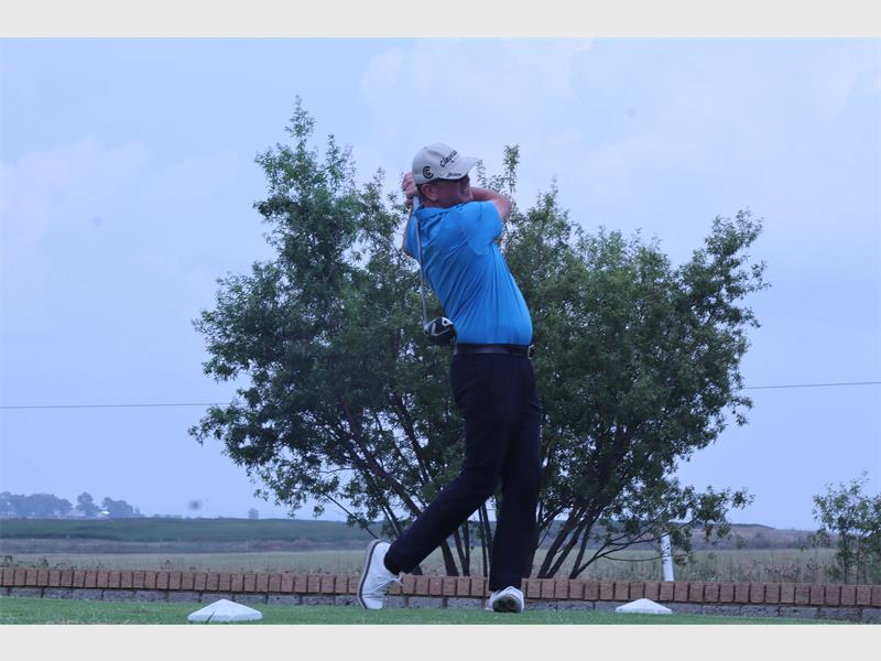 man with a blue shirt plays golf