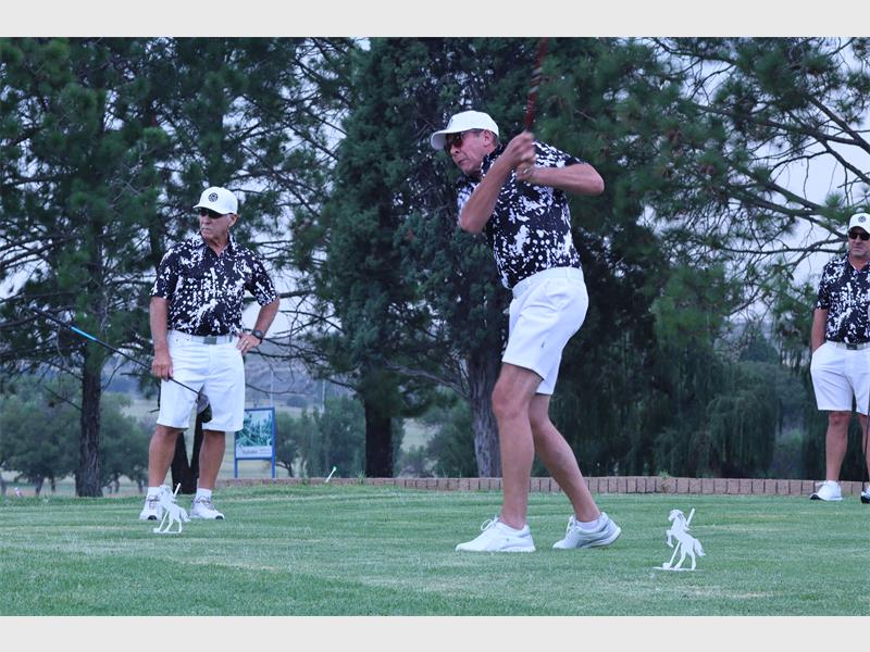 man in leopard print plays golf