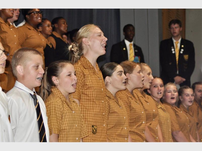 learners on a stage singing