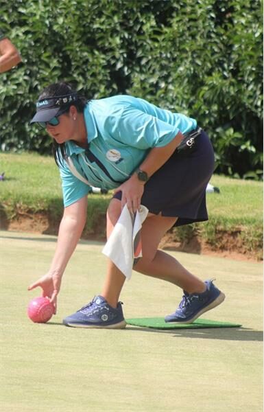 a woman plays bowls