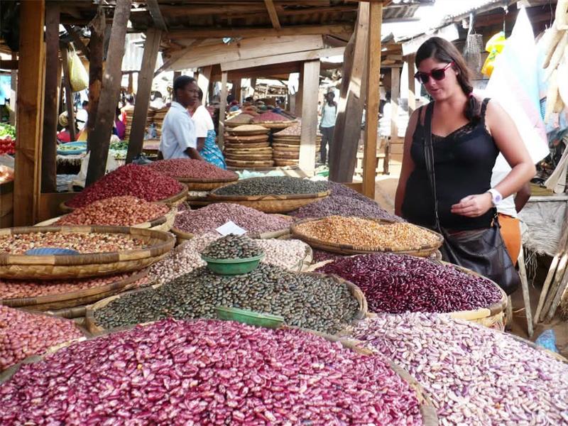 a woman at a table full of spices