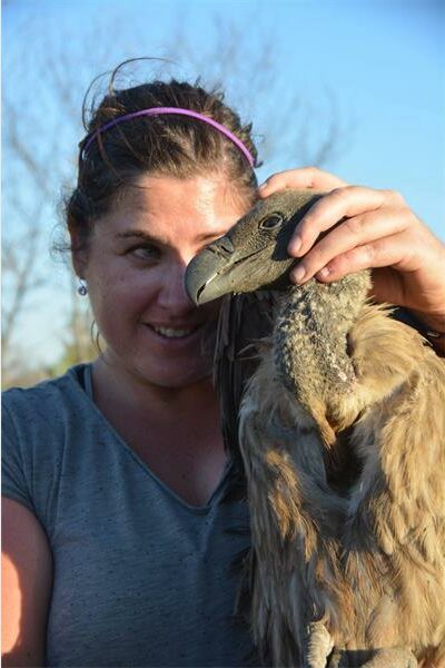 woman stroking a vulture's head