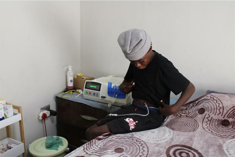boy is removing a dialysis tube
