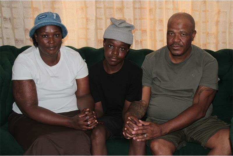 a young boy between his parents