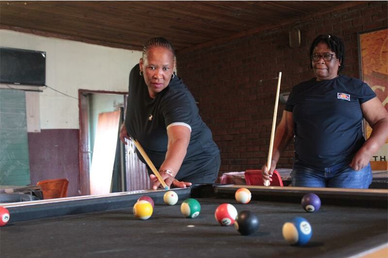 two women playing pool