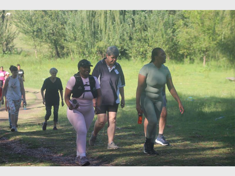 a group of people walk in a park