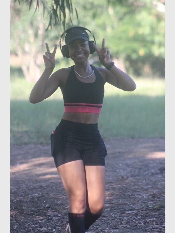 woman runs with earphones on her head