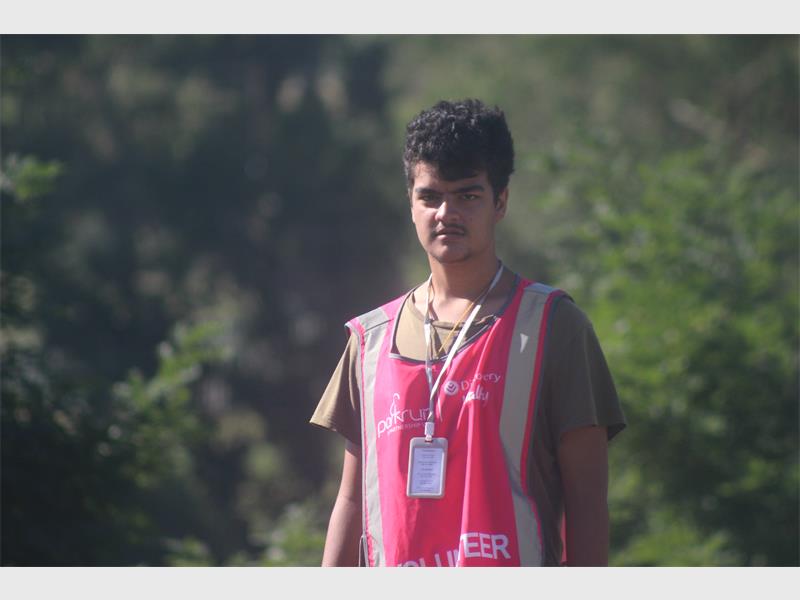 a man with a pink volunteer bib