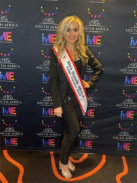 blonde woman wears a sash