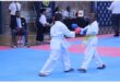 two karate students on a blue mat