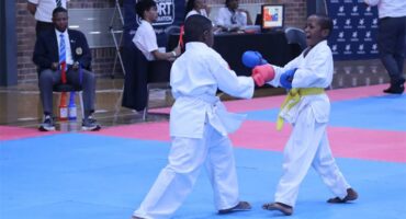 two karate students on a blue mat