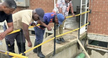 people look over a railing in plant