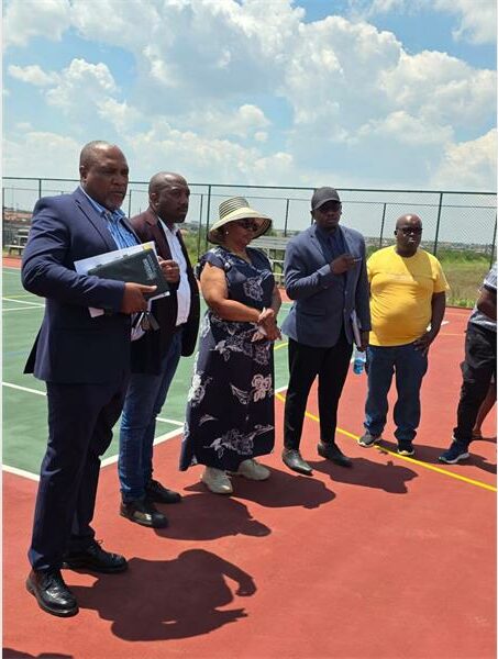 six people on a tennis court