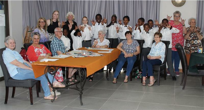 large group of elderly and school learners