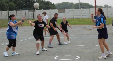 people play ring ball on a court.