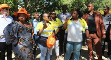 group of people standing in the shade