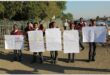 learners hold up posters against drugs
