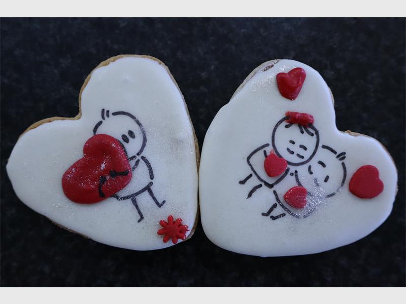 Two decorated heart-shaped cookies