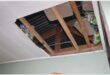 removed ceiling board with food stashed in the rafters