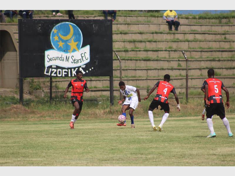team in red plays soccer against team in white